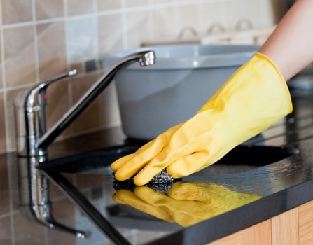 Technician preparing carpet cleaning equipment with safety checks